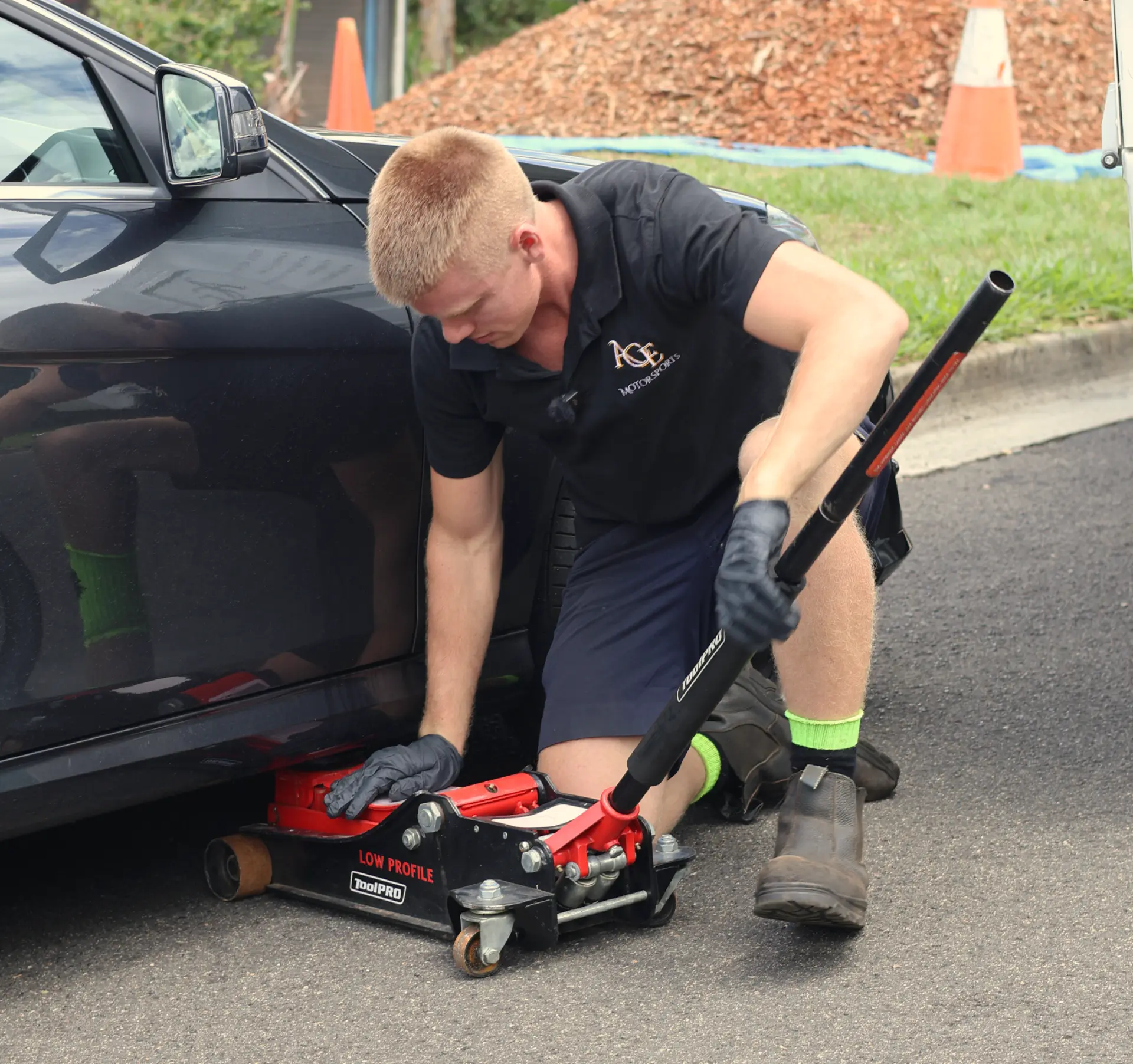 Ace Motorsports inspector jacking up a car during a mobile roadworthy inspection