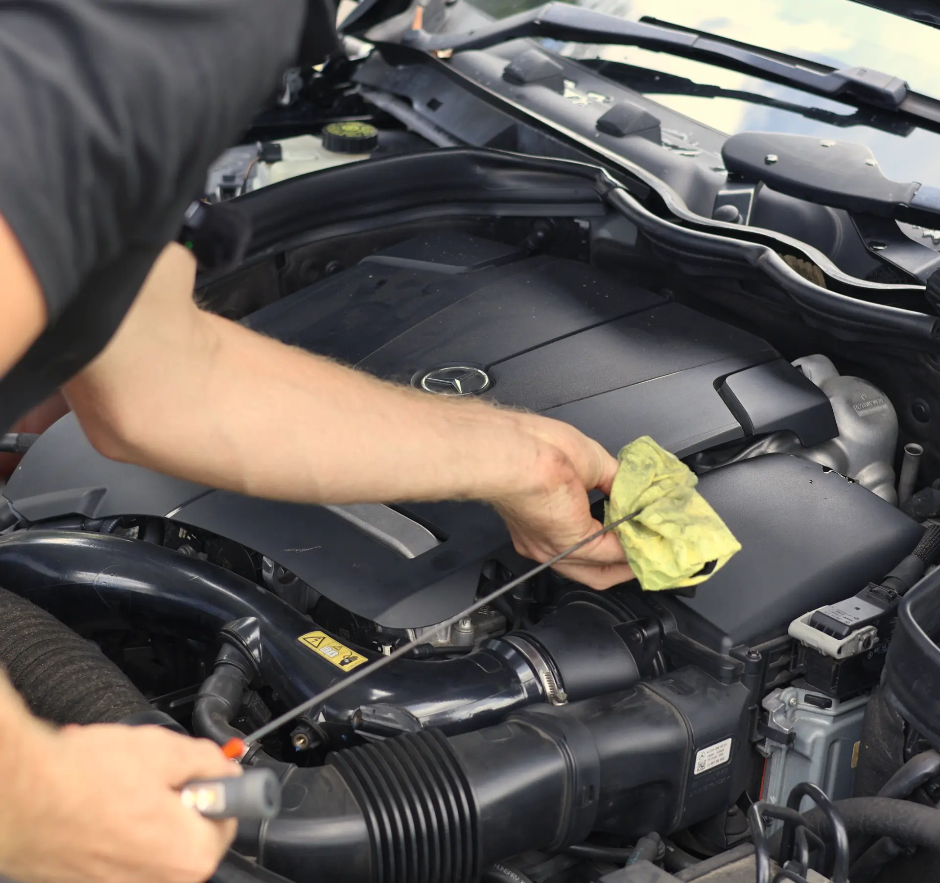 Checking engine oil level under the bonnet during an inspection