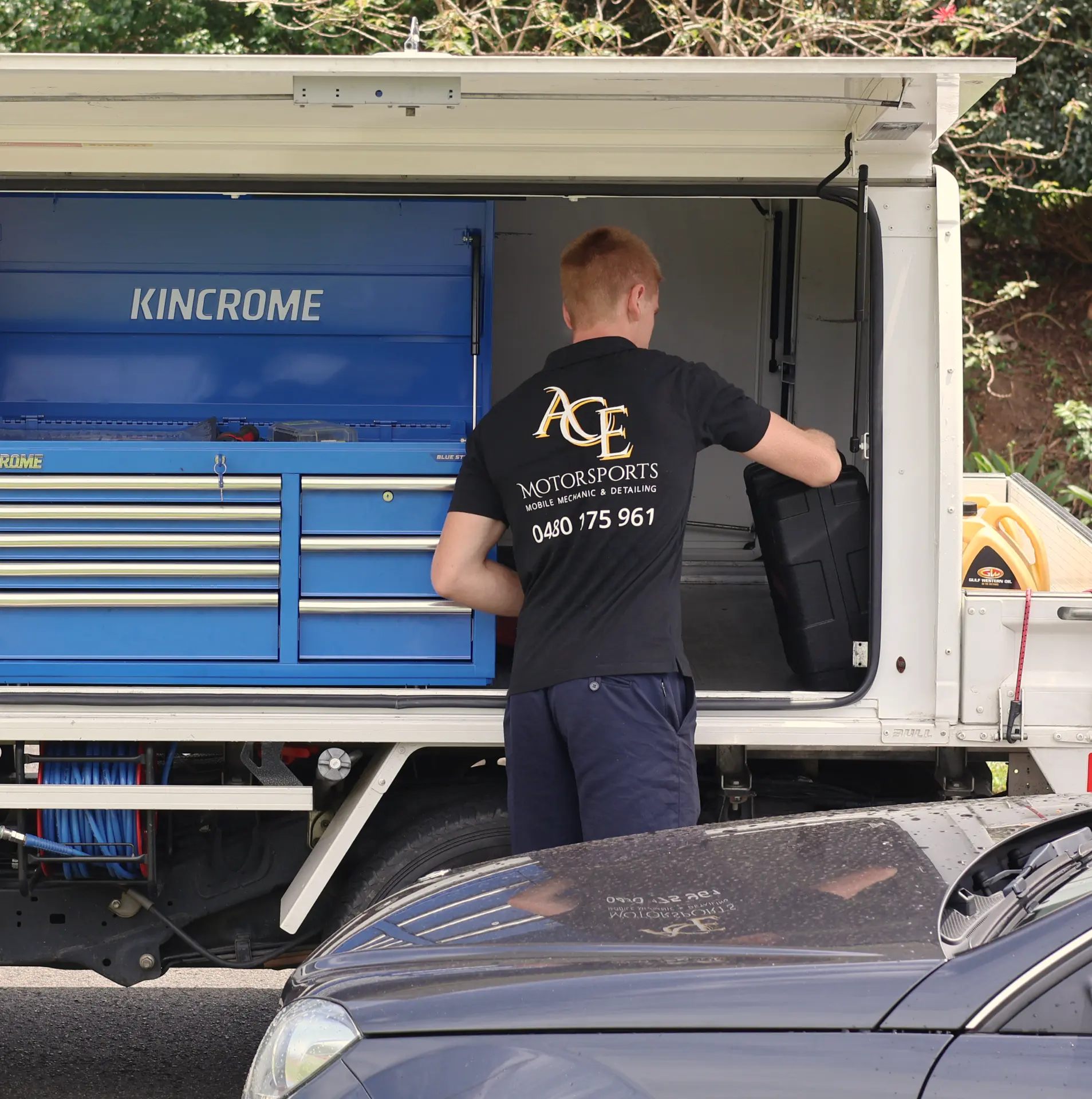 Ace Motorsports technician pulling tools from the fully equipped service ute